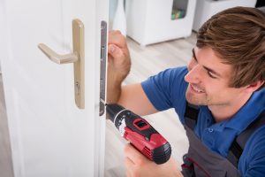 man installing lock for home in toronto