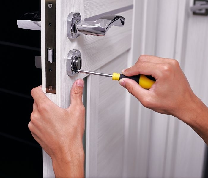 man installing new lock on door in scarborough